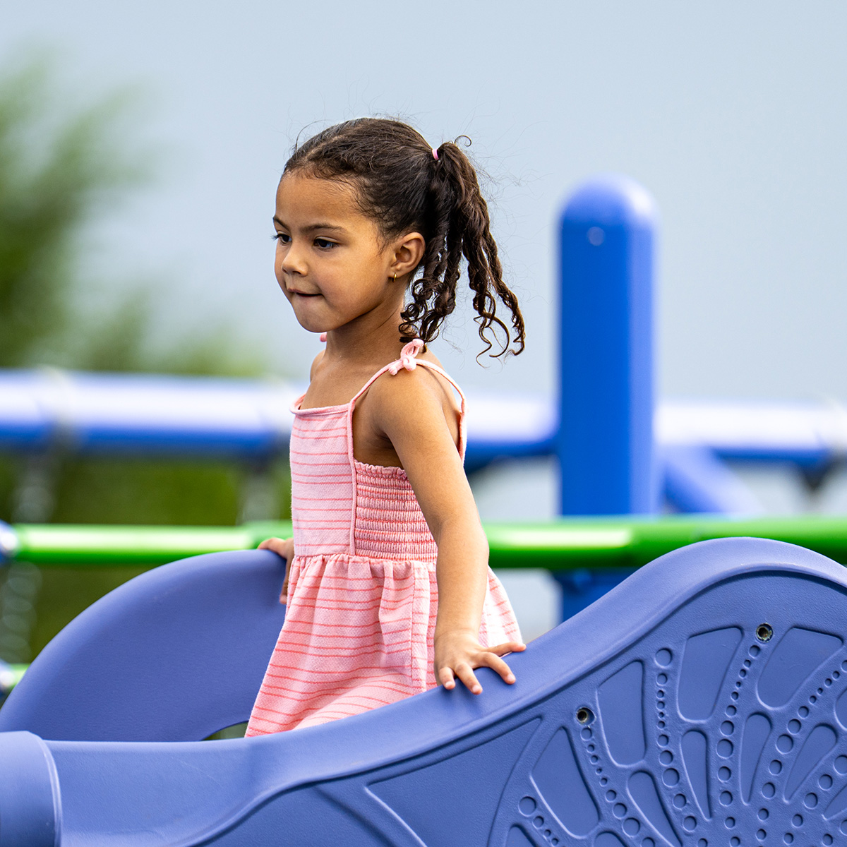 Young girl walking across new playground structure